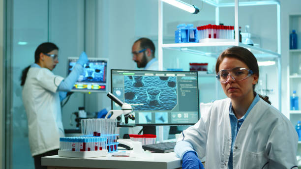 istock Portrait of scientist nurse looking exhausted at camera 1865368835