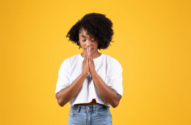 istock Serious millennial black woman in casual doing pray gesture with hands 1865383461
