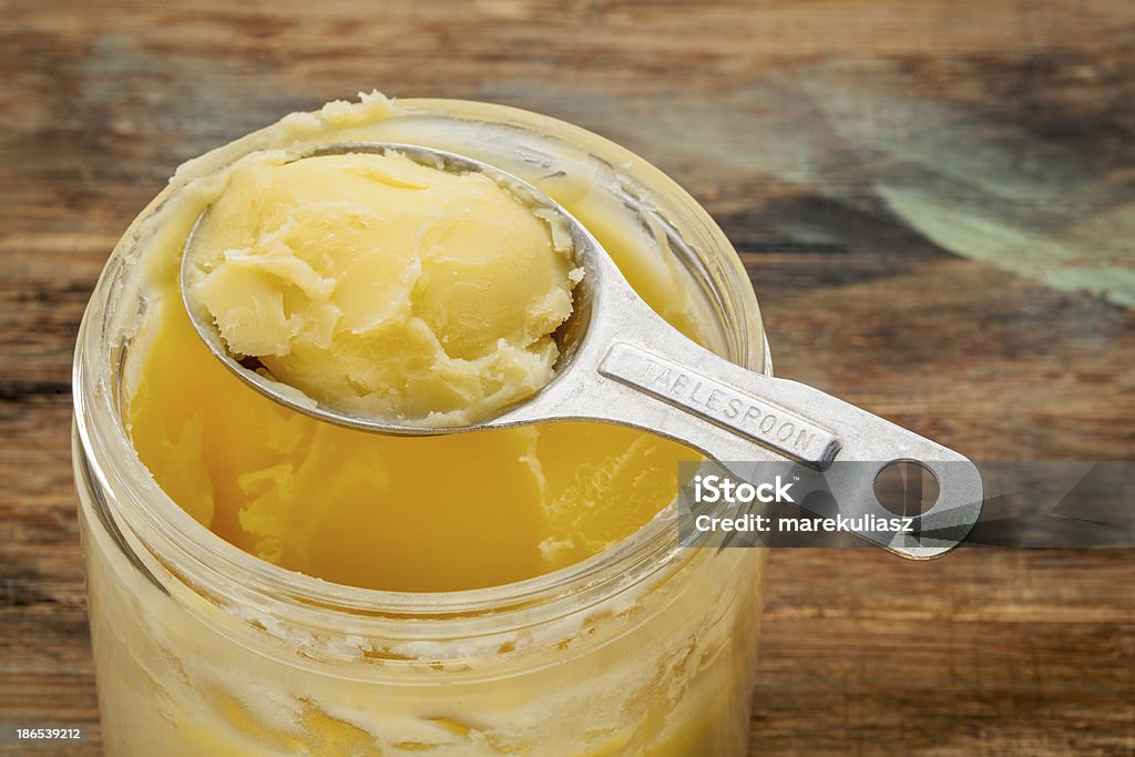 ghee - clarified butter jar and measuring tablespoon of ghee - clarified butter Butter Stock Photo