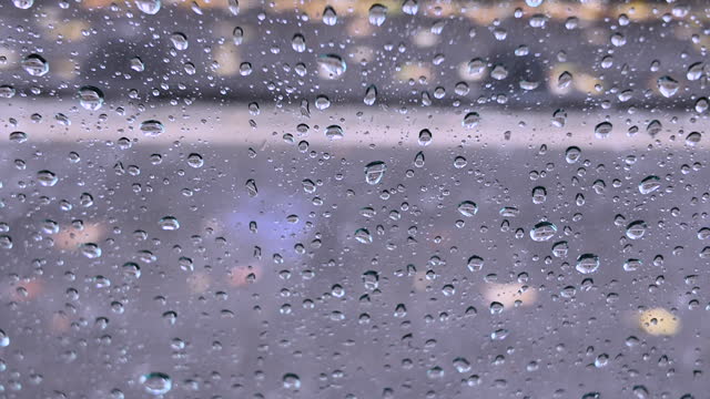Water drops on vehicle window on rainy day