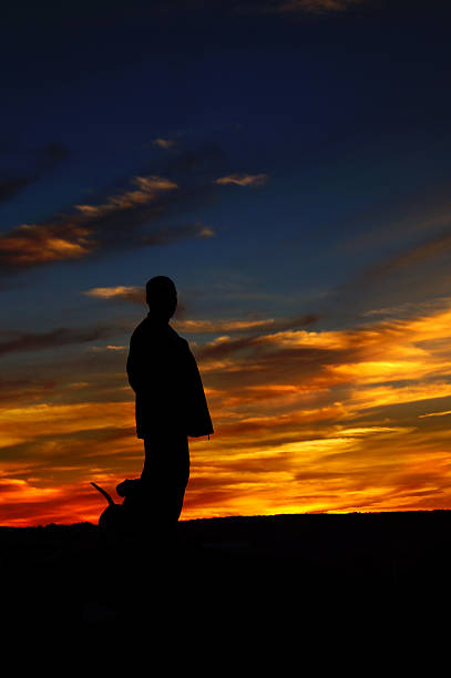 istock Man and Dachshund dog - back lit sunset background 186541336