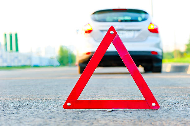 istock red warning triangle and a car with the emergency alarm 186542522