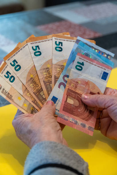 istock banknotes old woman hand 1865428709