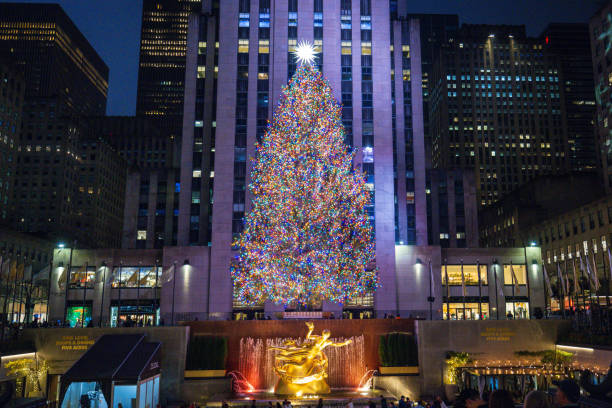 Christmas Tree at Rockefeller Center The Christmas tree and Prometheus statue at Rockefeller Center. December 2023. New York City, NY. USA rockefeller ice rink stock pictures, royalty-free photos & images