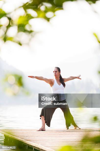 Warrior Pose During Yoga Exercise Stock Photo - Download Image Now - 30-39 Years, 35-39 Years, Adult
