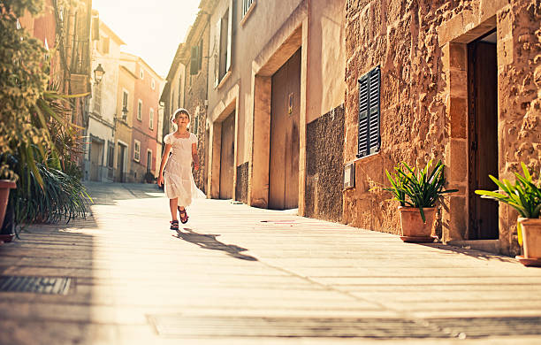 Little mediterranean girl Little girl walking beautiful street of a mediterranean town. bay of alcudia stock pictures, royalty-free photos & images