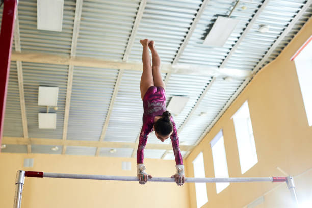 istock Training Girl Gymnast Pausing in Handstand on Uneven Bars 1865437178