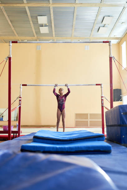 istock Girl Gymnast Learning Uneven Bars 1865437224