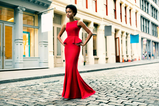 Fashion in New York City Woman wearing a red gown in Soho, New York evening gown photos stock pictures, royalty-free photos & images
