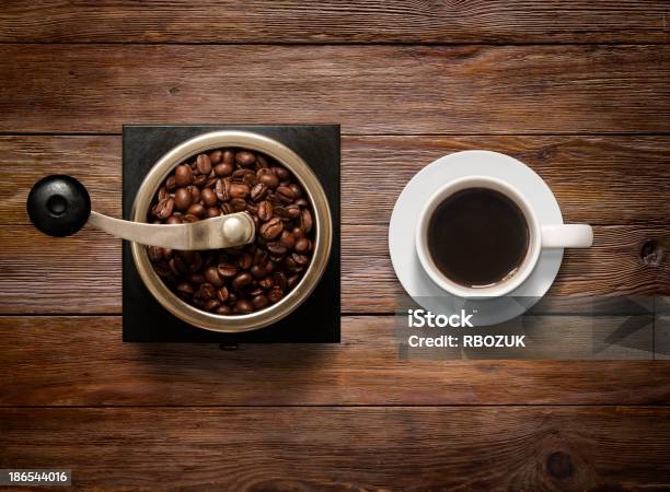 Overhead Shot Of Coffee Cup And Grinder On Wooden Background Stock Photo - Download Image Now