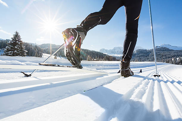 Cross-Country Skiing in European Alps Close-up of a mans legs doing cross-country skiing. back country skiing photos stock pictures, royalty-free photos & images