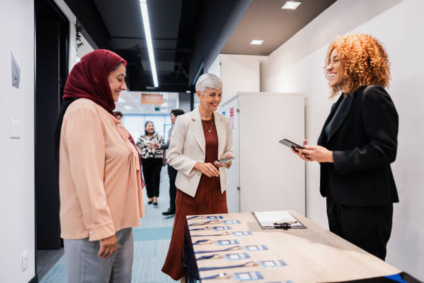 istock Business conference participants registering for a conference 1865459375