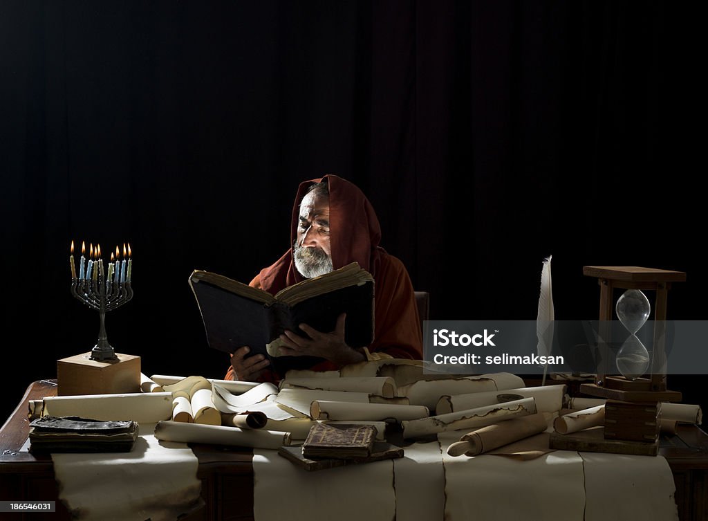 Medieval philosopher reading Torah in the light of menorah Torah Stock Photo