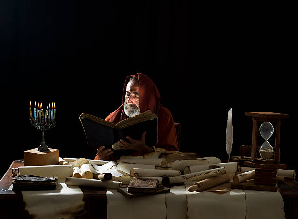 Medieval philosopher reading Torah in the light of menorah Medieval philosopher reading Torah in the light of menorah hasidism photos stock pictures, royalty-free photos & images