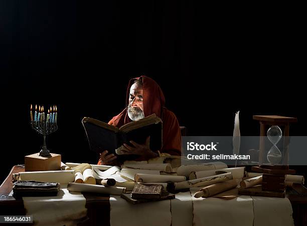 Medieval Philosopher Reading Torah In The Light Of Menorah Stock Photo - Download Image Now