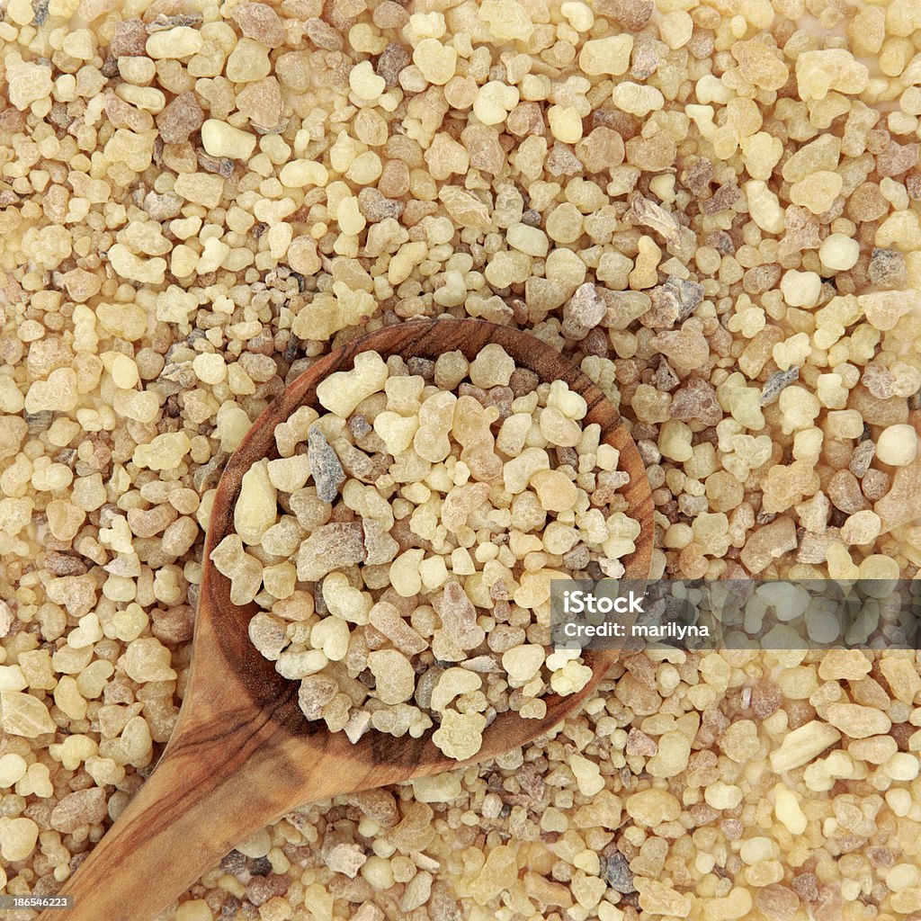 Frankincense and Myrrh Frankincense and myrrh in a wooden spoon and forming a background. Backgrounds Stock Photo