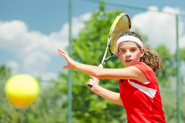 Young tennis champion, hitting forehand