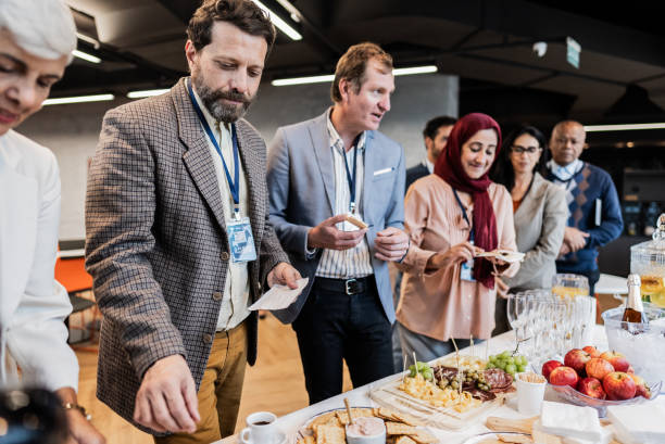istock Business people getting food during conference coffee break 1865465613