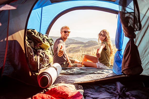 Young couple during camping stock photo