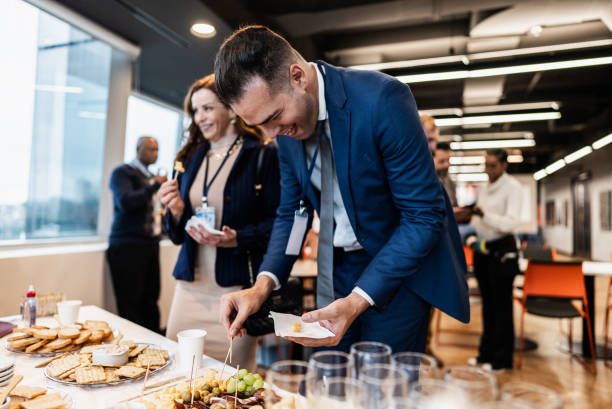 Business people getting food during conference coffee break