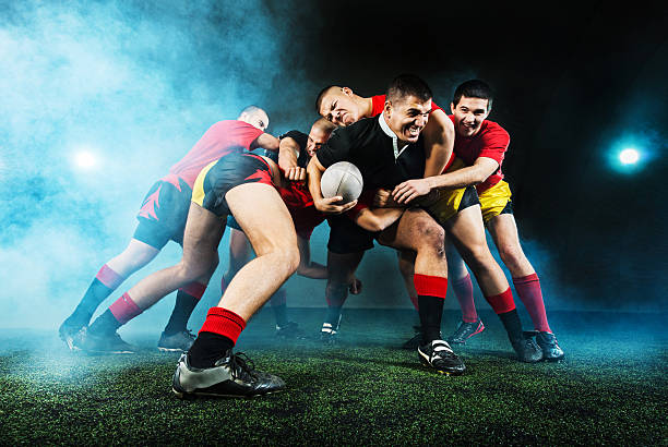 Rugby action at night. Rugby players in action during the night.    rugby team stock pictures, royalty-free photos & images