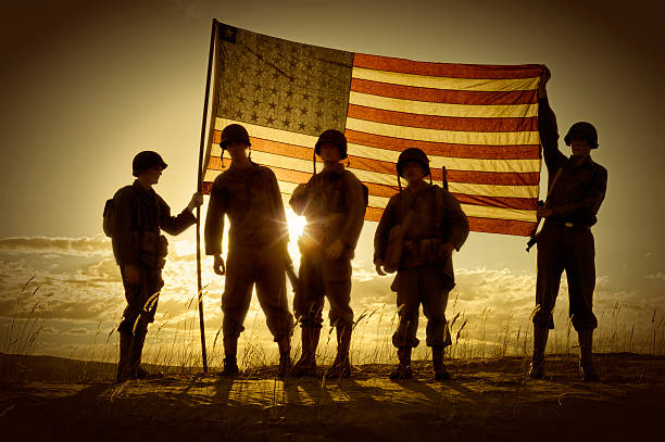 Silhouette of soldiers with American flag stock photo