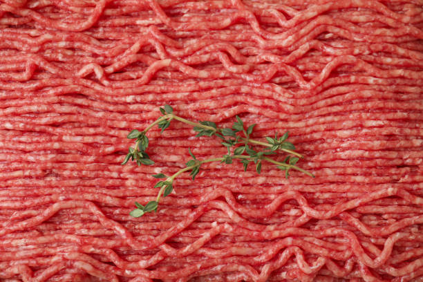 istock Fresh raw ground meat and thyme, top view 1865475604
