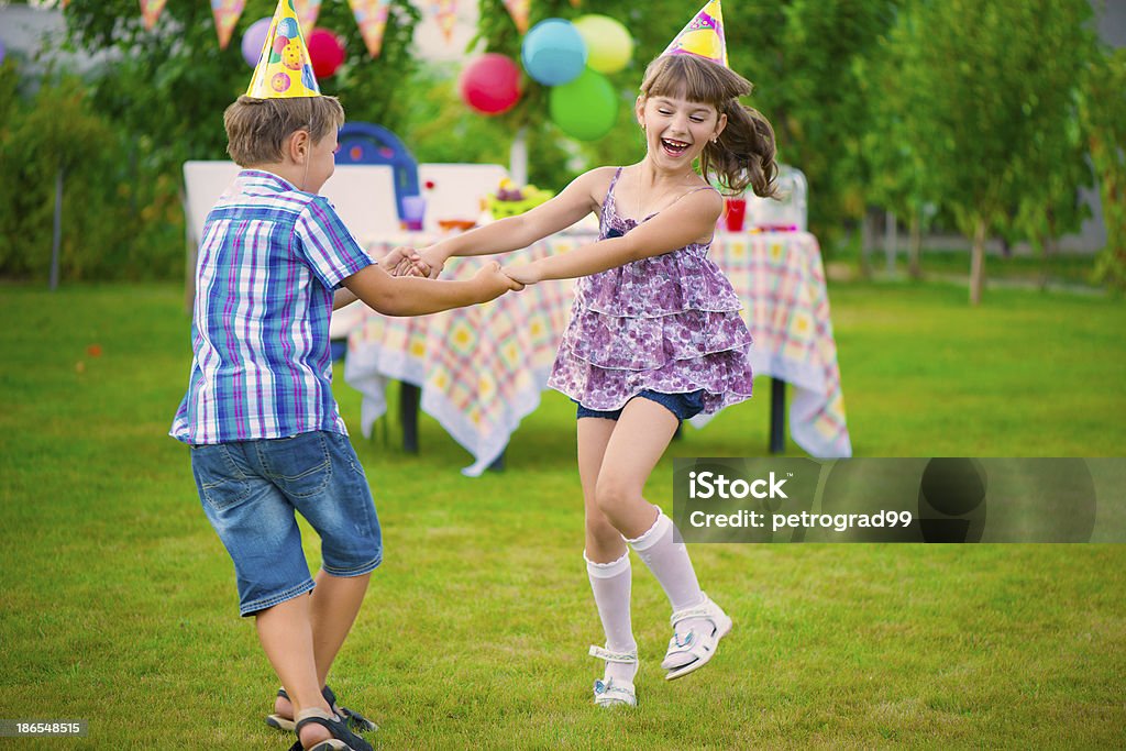 Two little kids dancing roundelay Two little kids celebrating birthday dancing roundelay Birthday Stock Photo