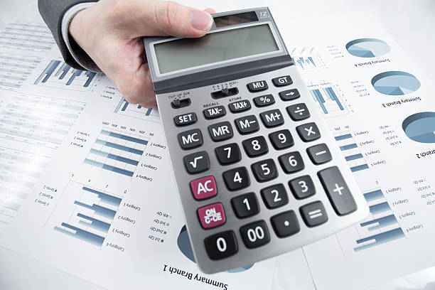 istock Man hand with pen and business report on table 186548542