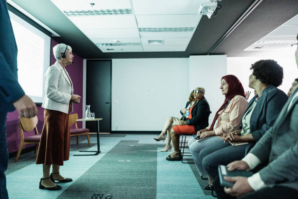 Group of presenters interacting with online presenters on a business presentation