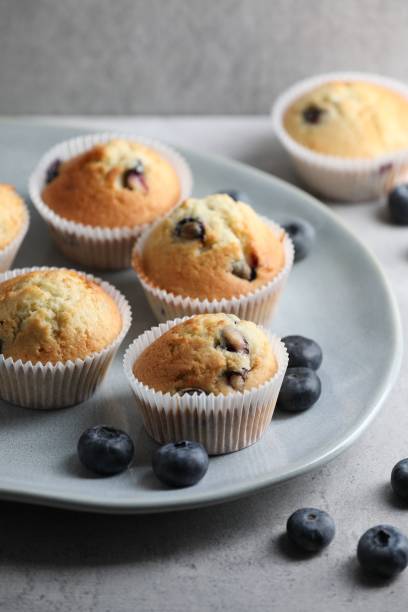 istock Delicious sweet muffins with blueberries on grey table 1865492790