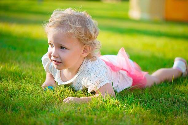 istock Pretty blonde girl lying on grass 186551293