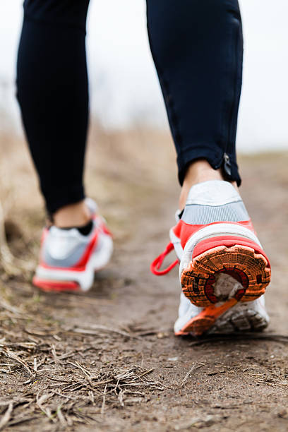 istock Walking or running legs sport shoes 186551669