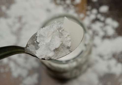 tablespoon very white baking powder viewed from above. white powder like baking soda