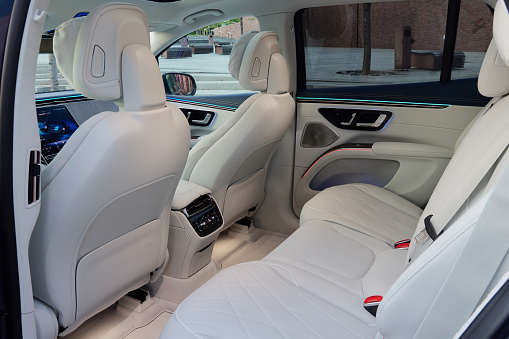 Rear seats of the electric Mercedes EQS SUV. White luxurious interior. Katowice, Poland, 05.28.2023