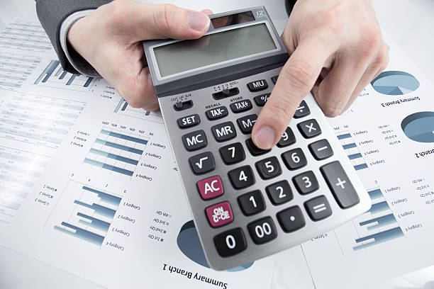 istock Man hand with pen and business report on table 186554064