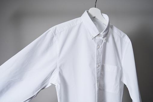 Whitebutton up shirt mockup, school uniform. gray background, studio shot. Mock up for design and branding logo, close up