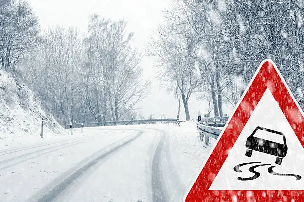 Sudden and heavy snowfall on a country road. Driving on it becomes dangerous …