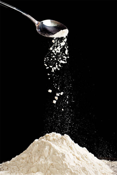 istock Flour fall down in air. Black background Isolated, selective focus 1865543937