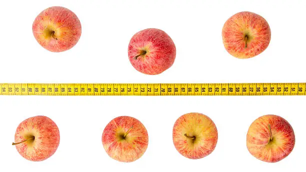 Apple diet, red apples with a yellow tape-measure