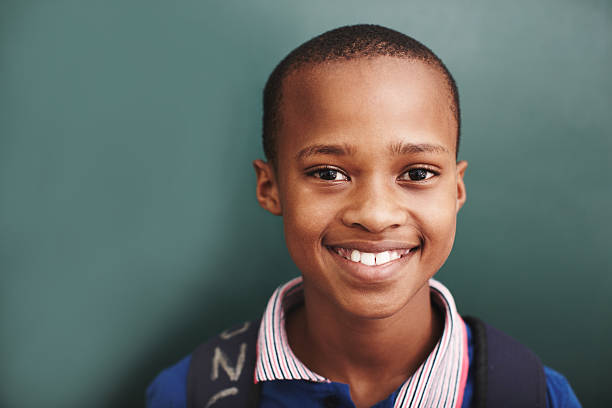 He's the bright star in his classroom An african american boy standing alongside copyspace at the blackboard confident boy stock pictures, royalty-free photos & images