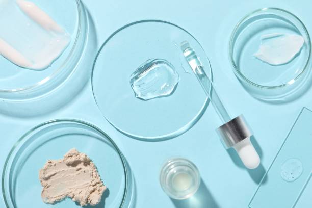 istock Bottle of cosmetic serum and petri dishes with samples on light blue background, flat lay 1865559095
