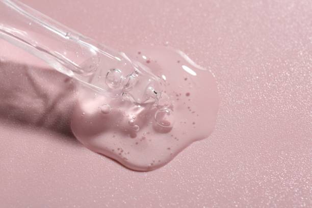 istock Pipette with cosmetic serum on pink background, closeup 1865564449