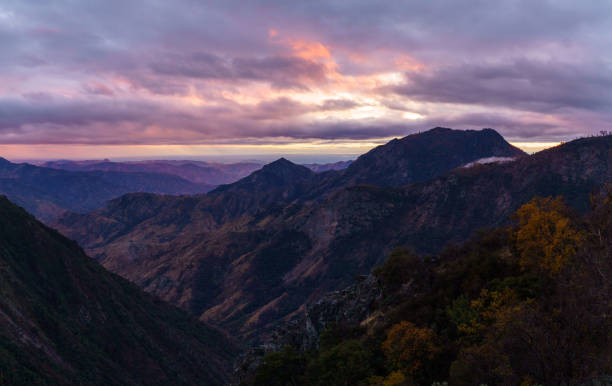 The mountains of Little Cottonwood Canyon in Utah at sunset with snow