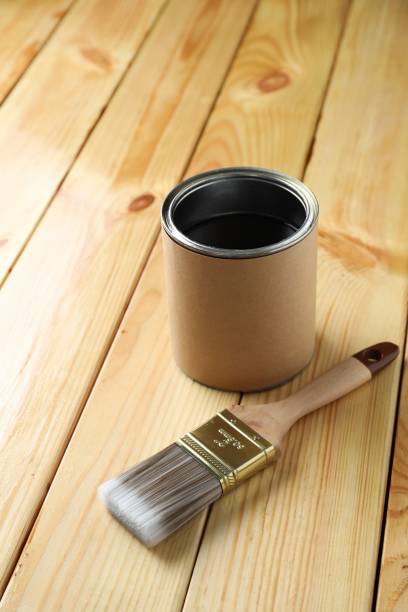 istock Can with wood stain and brush on wooden surface 1865570927