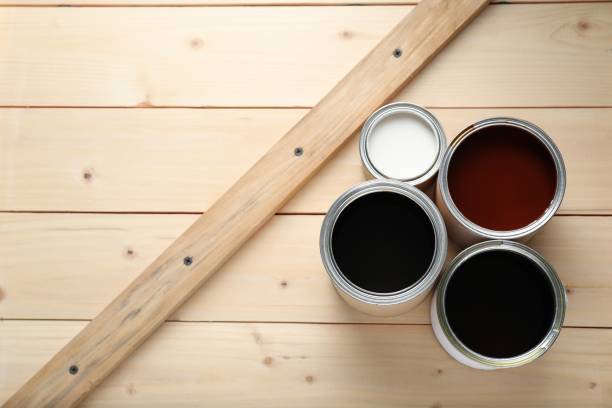 istock Cans with different wood stains and varnish on wooden surface, flat lay. Space for text 1865572514