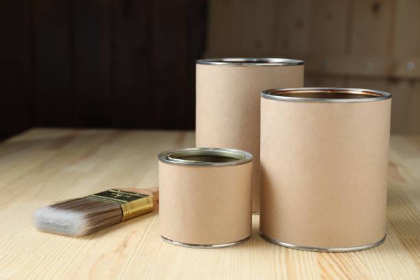 istock Cans with different wood stains and brush on wooden surface, space for text 1865573020