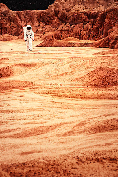istock Astronaut Walking On Mars or the Moon 186557383