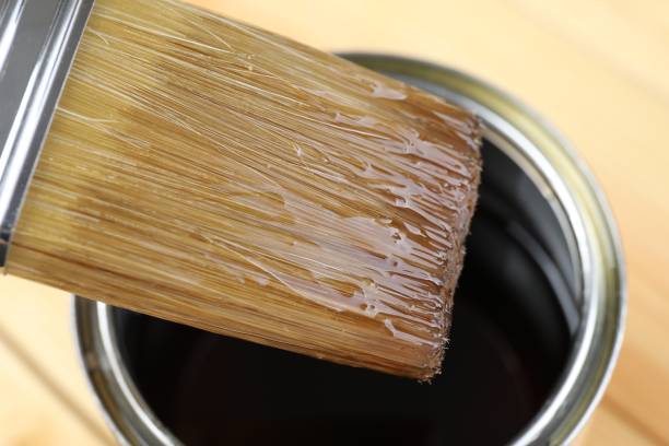 istock Brush with varnish over can on table, closeup 1865574622