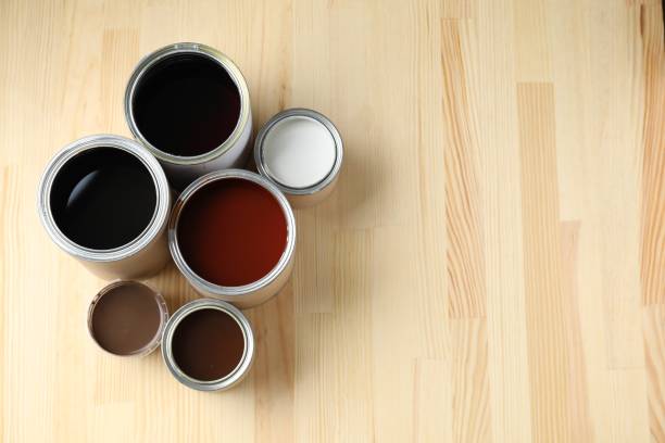 istock Cans with different wood stains and varnish on wooden surface, flat lay. Space for text 1865575144